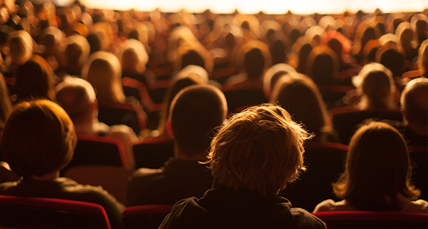 a number of people sitting in a theatre